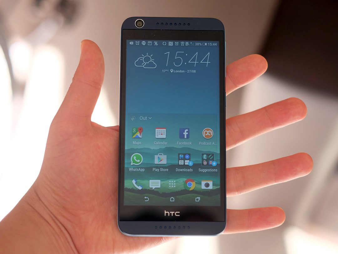 HTC Desire 626 in hand displaying the home screen