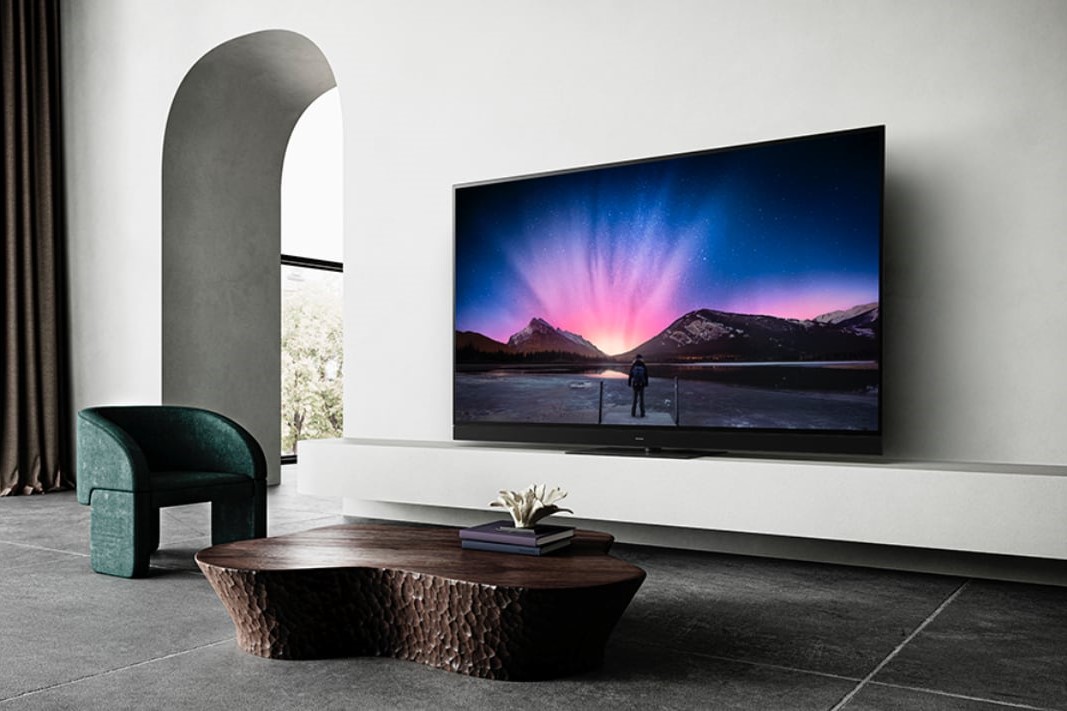 A wall-mounted Panasonic TV in the minimalist living room