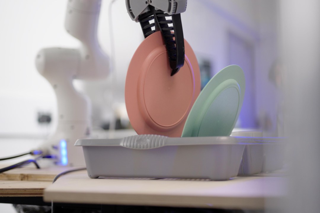 Dyson Household robot placing dishes into a drying rack