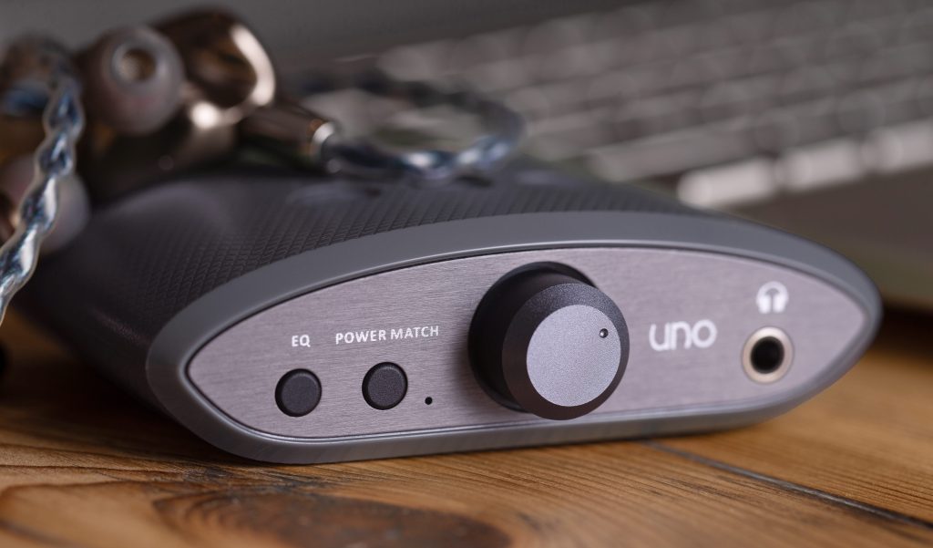 iFi's Uno DAC amplifier up-close next to a laptop