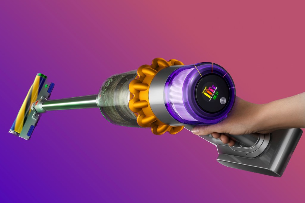 Dyson V15 Detect Absolute held by hand against purple background