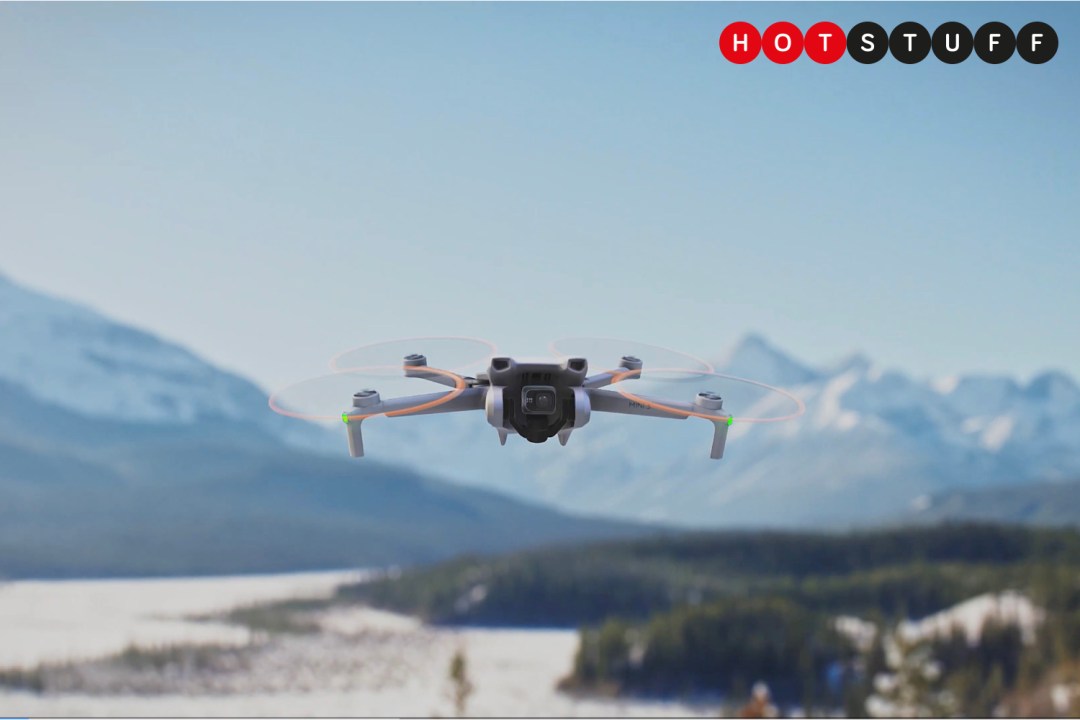 DJI Mini 3 flying above a snowy mountain range