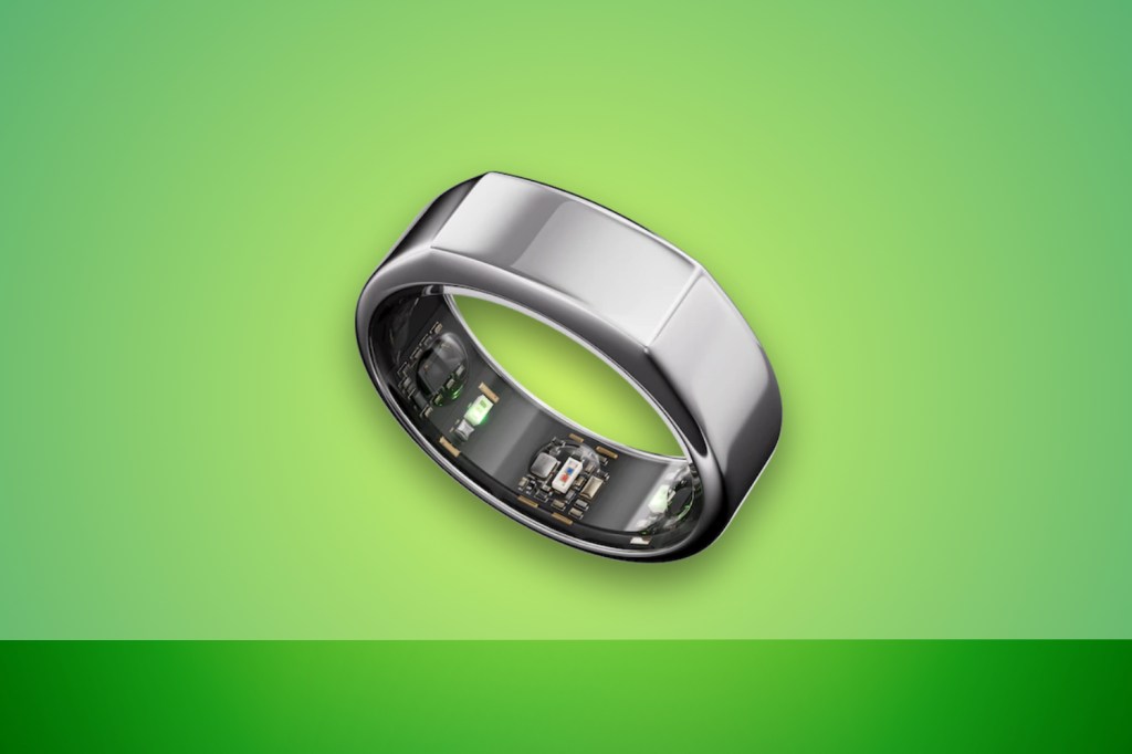 Oura smart ring against green background