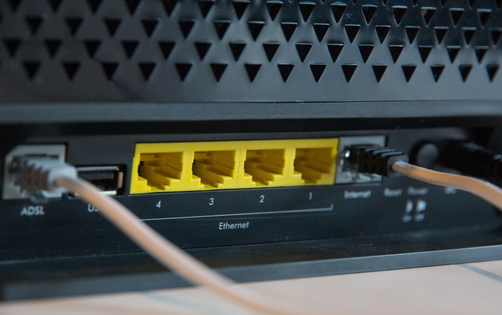 The Ethernet ports on the back of a router. Image by Stephen Philips on Unsplash.
