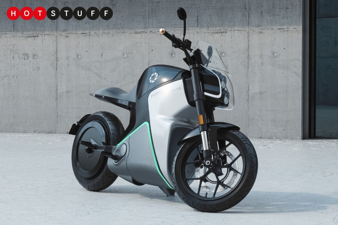 Parked motorbike on concrete. The handlebars are turned slightly to the left.