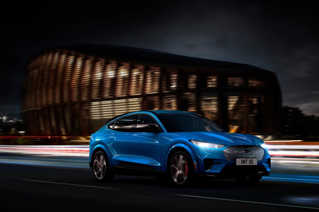 Blue Ford Mach E driving on motorway at night