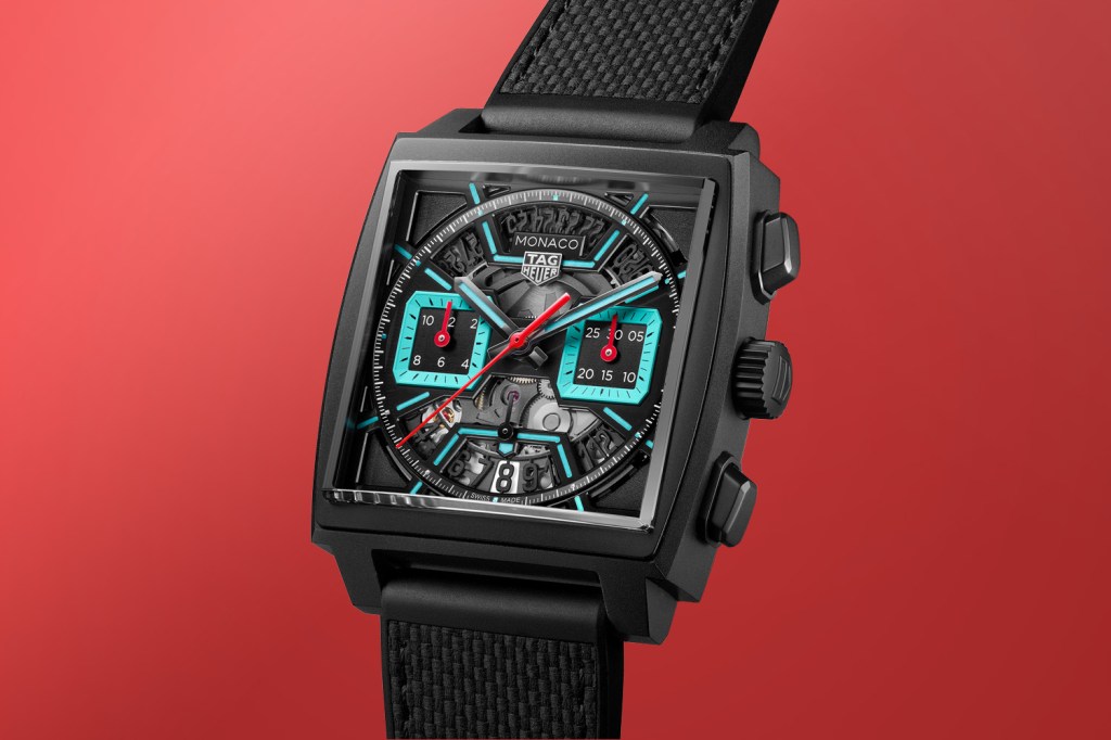 Black TAG Heuer Monaco with a skeleton dial. One red background.