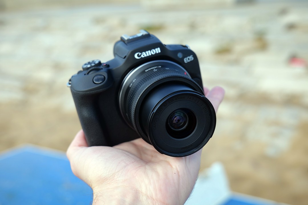 canon eos r100 in hand