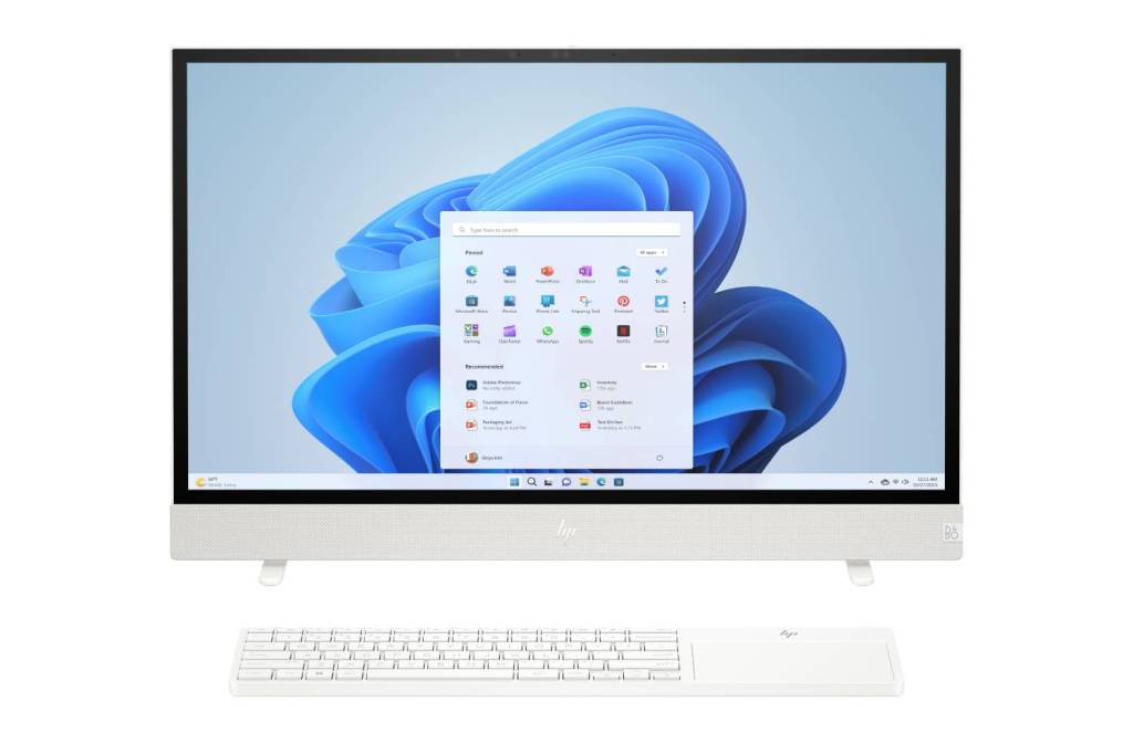 HP Envy Move all-in-one PC on a white background. A wireless keyboard sits in front of it and a Windows 11 interface is visible on the screen.