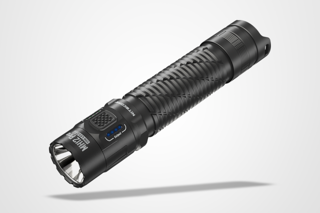 Best torches round-up: Nitecore MH12 Pro flashlight pictured on a grey background with a drop shadow.