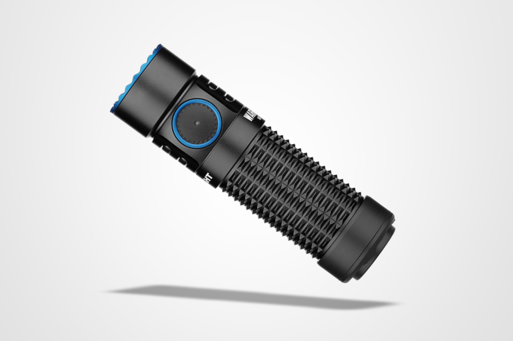 Best torches round-up: Olight Warrior Nano flashlight pictured on a grey background with a drop shadow.