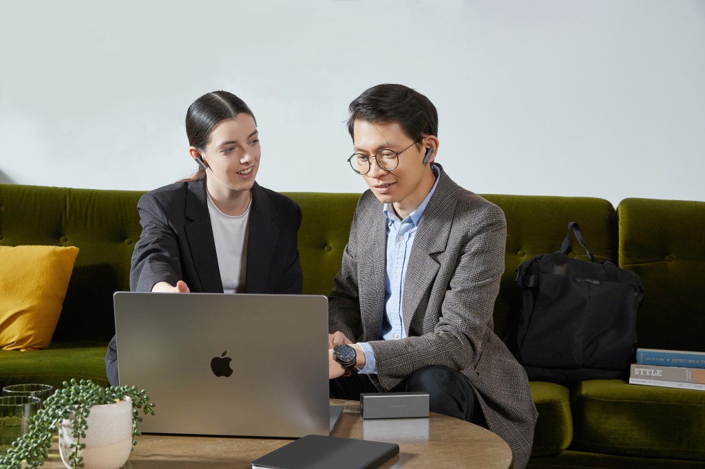 Timekettle X1 Interpreter Hub being used by a woman and a man