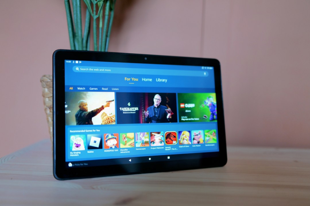 Amazon Fire HD 10 tablet leaning on a plant pot, showing screen