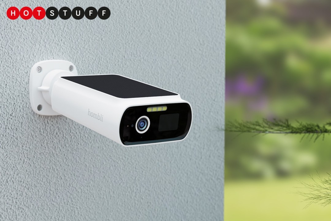 Hombli Smart Solar Cam 2K mounted on a wall with greenery in the background