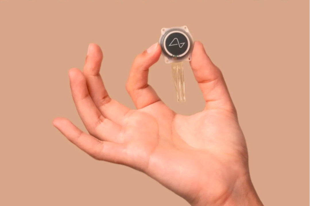 The Neuralink implant being held in hand