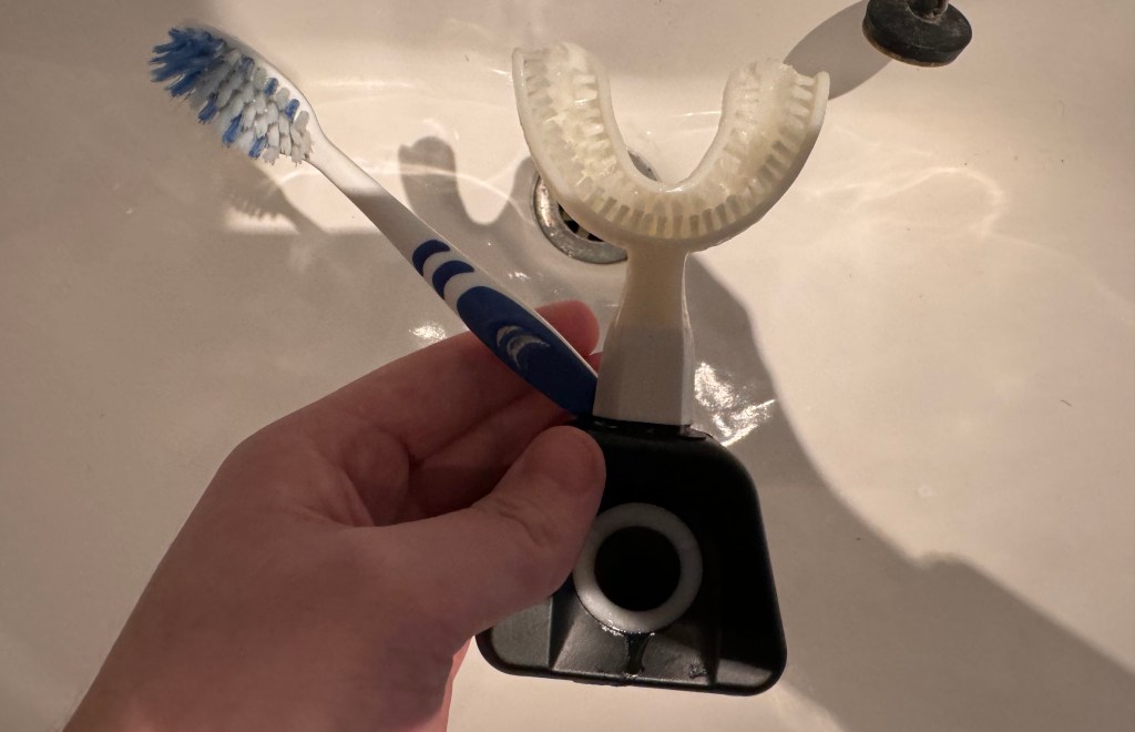A normal toothbrush and the Y-Brush