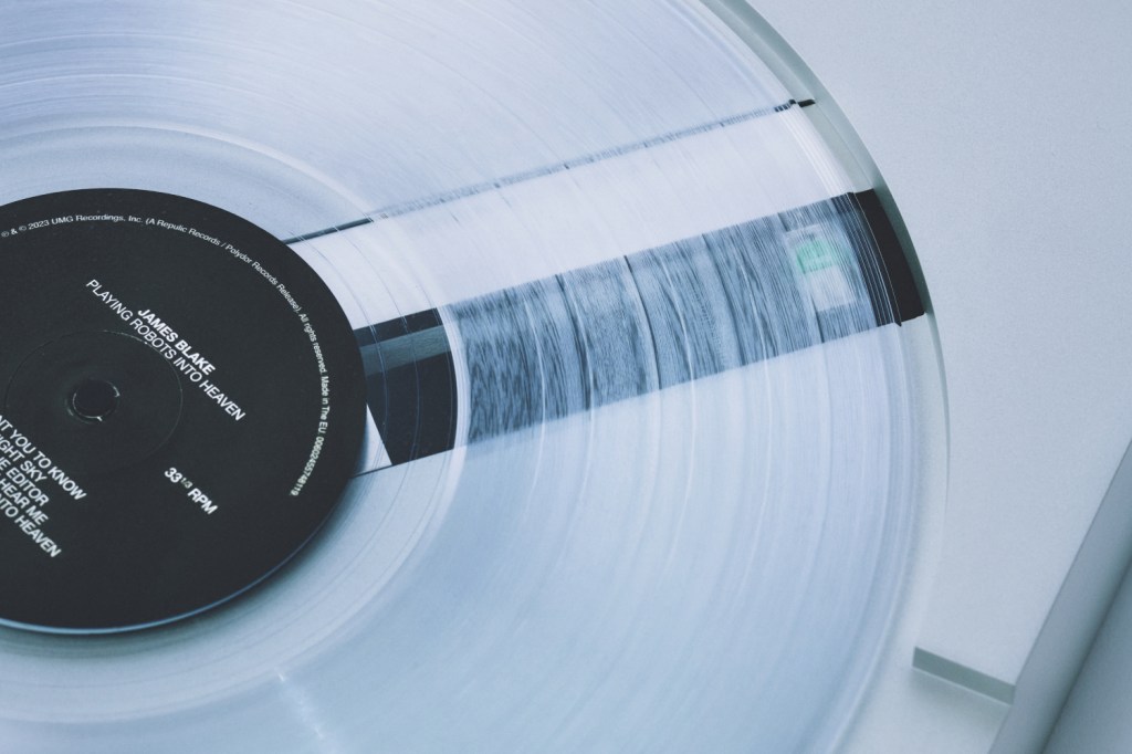 A close-up of the PP-1 turntable playing a translucent record.