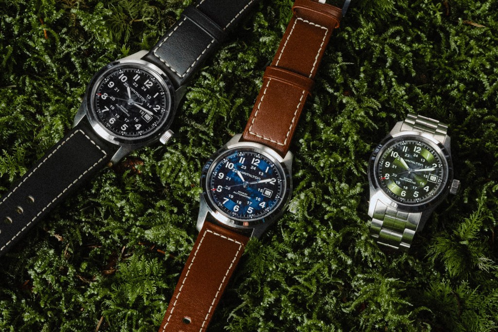 Three Hamilton Khaki Field watches on moss
