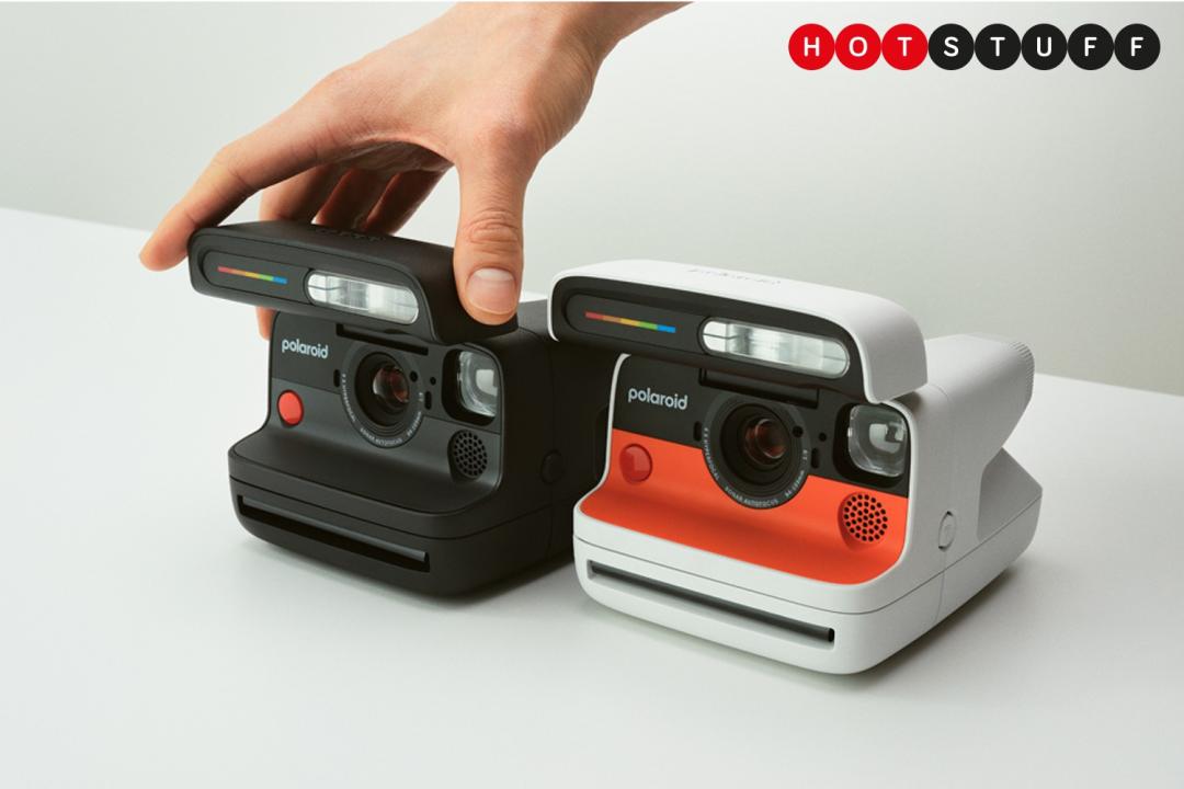 Two Polaroid Flip instant cameras – black on the left, white on the right – with a hand reaching into the frame to touch the flash module of the black model.