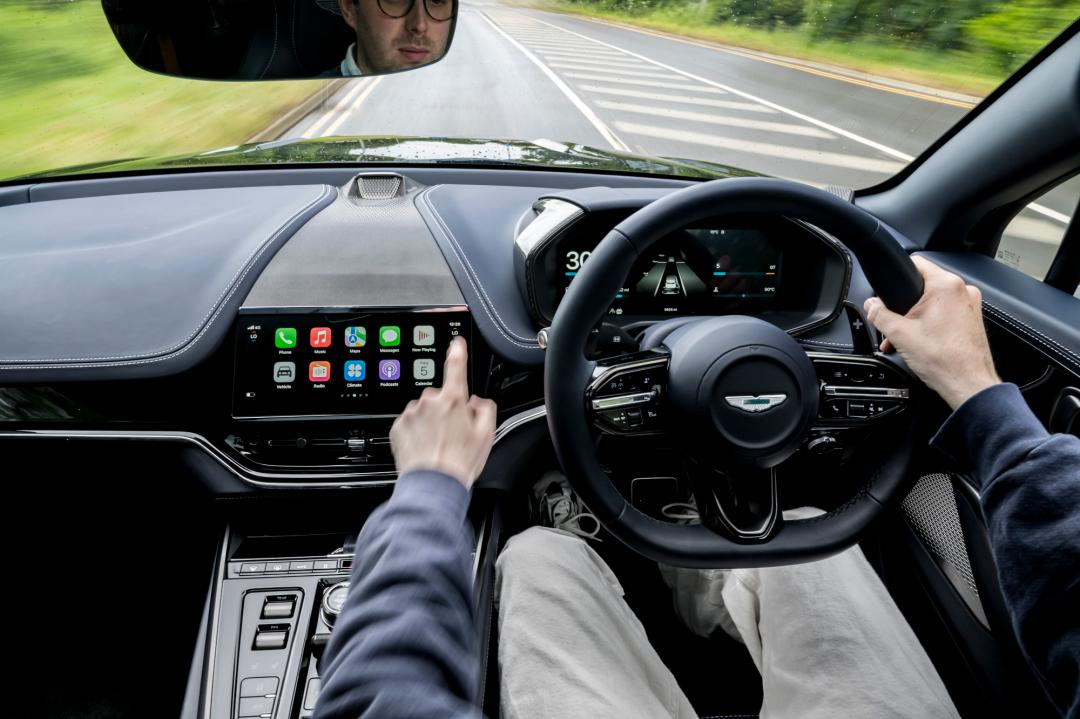 Person driving a car with Apple CarPlay Ultra