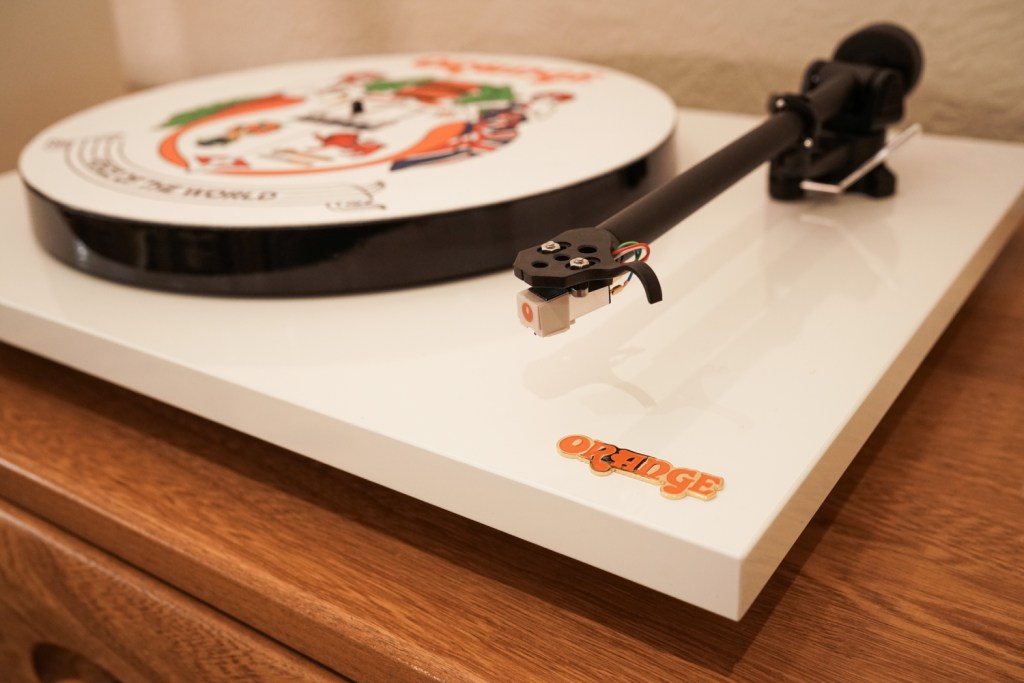 A close-up of the tonearm on an Orange Amps O Turntable.
