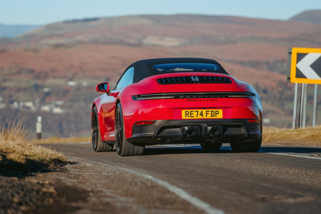 Porsche 911 GTS Cabriolet driving roof up rear
