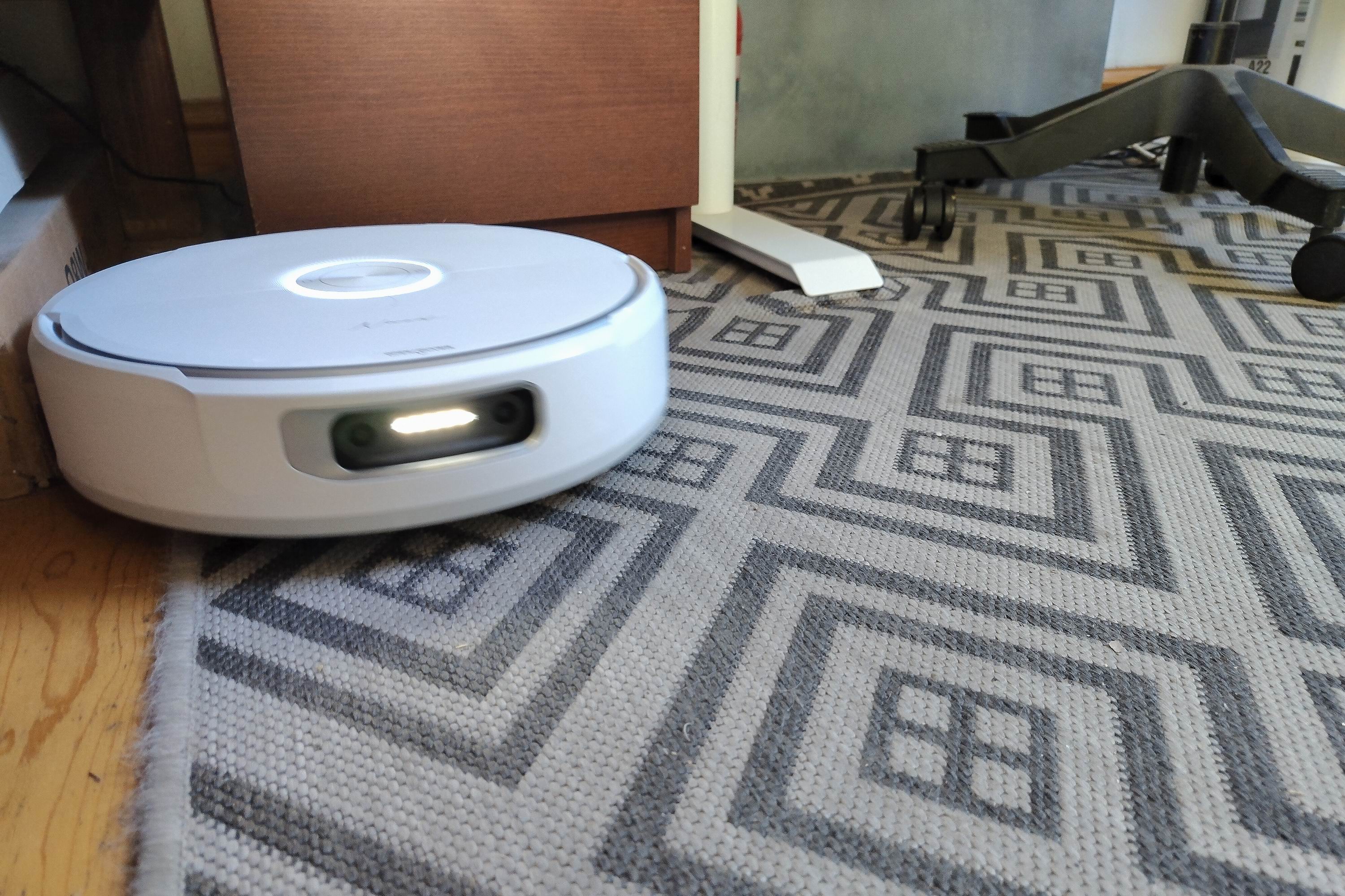 A robot vacuum cleaner on a patterned rug