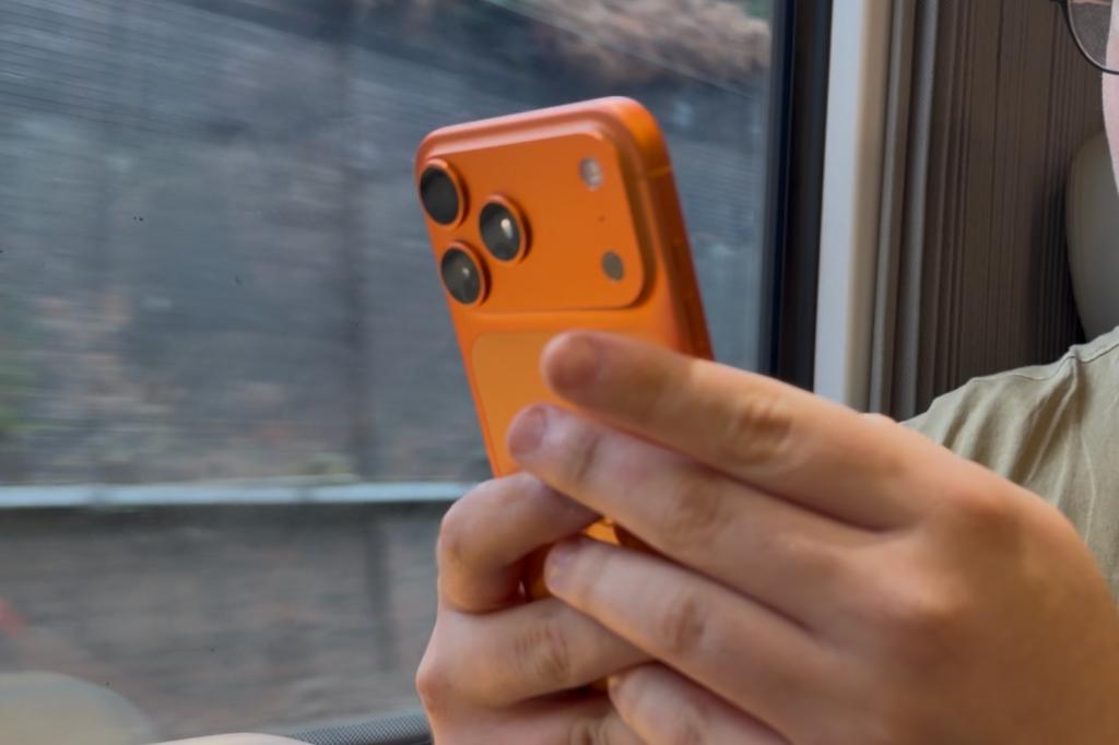 iPhone 17 Pro Max being held while being used when travelling