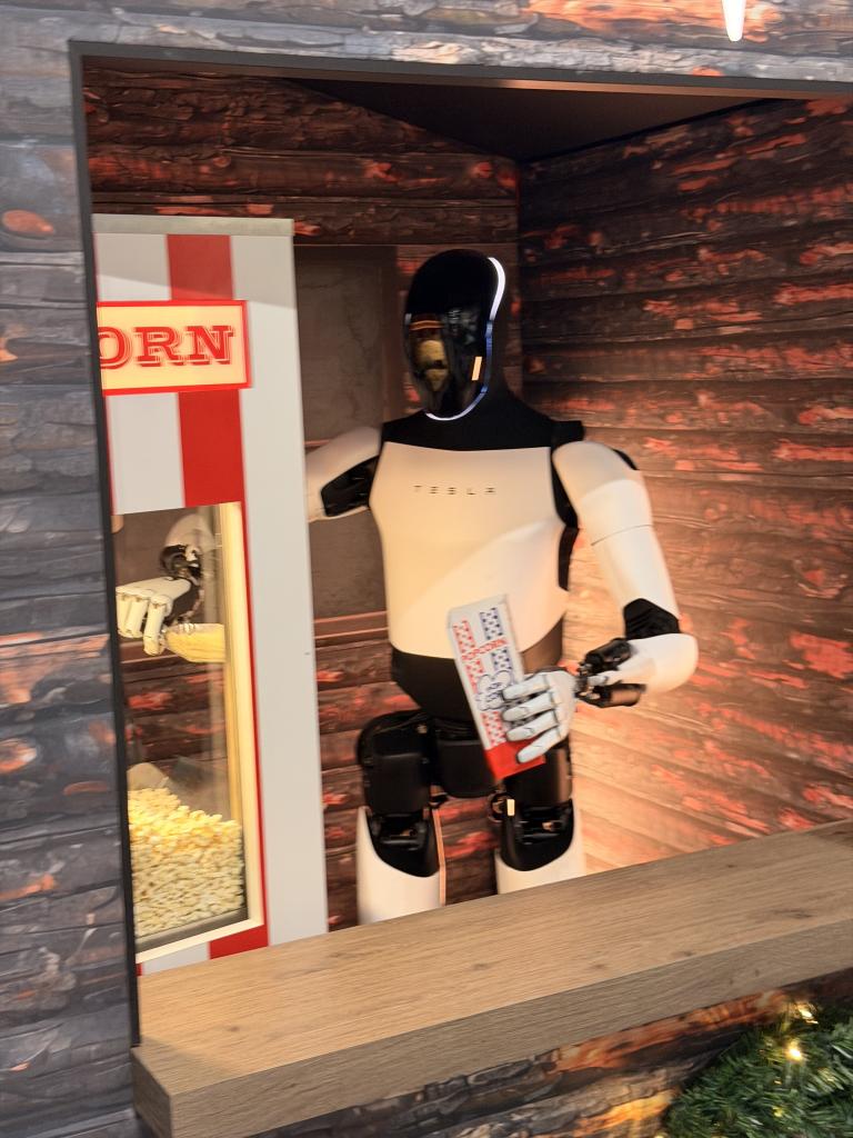 Tesla's Optimus scooping popcorn