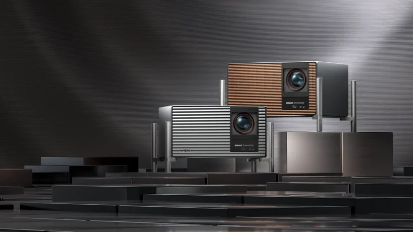 A pair of Xgimi Titan Noir Max projectors on a raised platform. The one on the left is grey, the one on the right is brown.