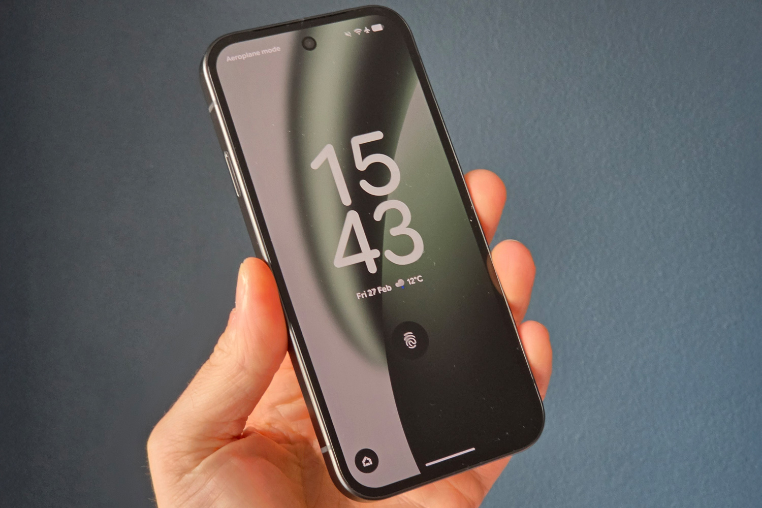 Google Pixel 10a review in hand lockscreen