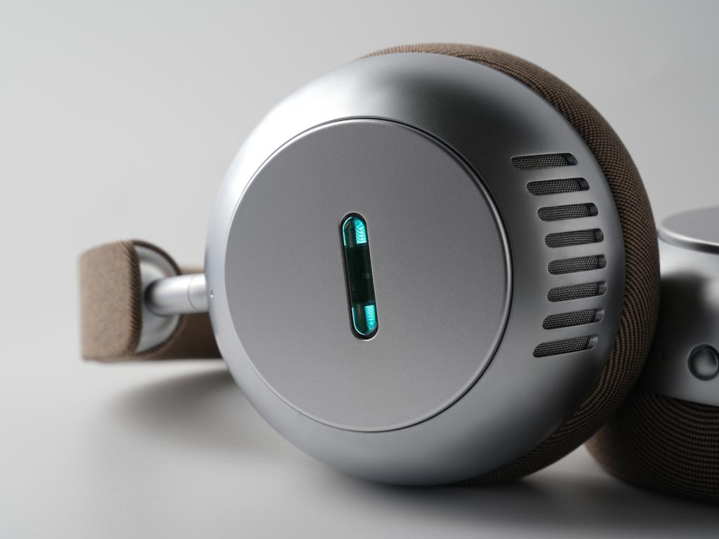 A close-up of the glowing blue vacuum tube inside the Écoute TH1 headphones