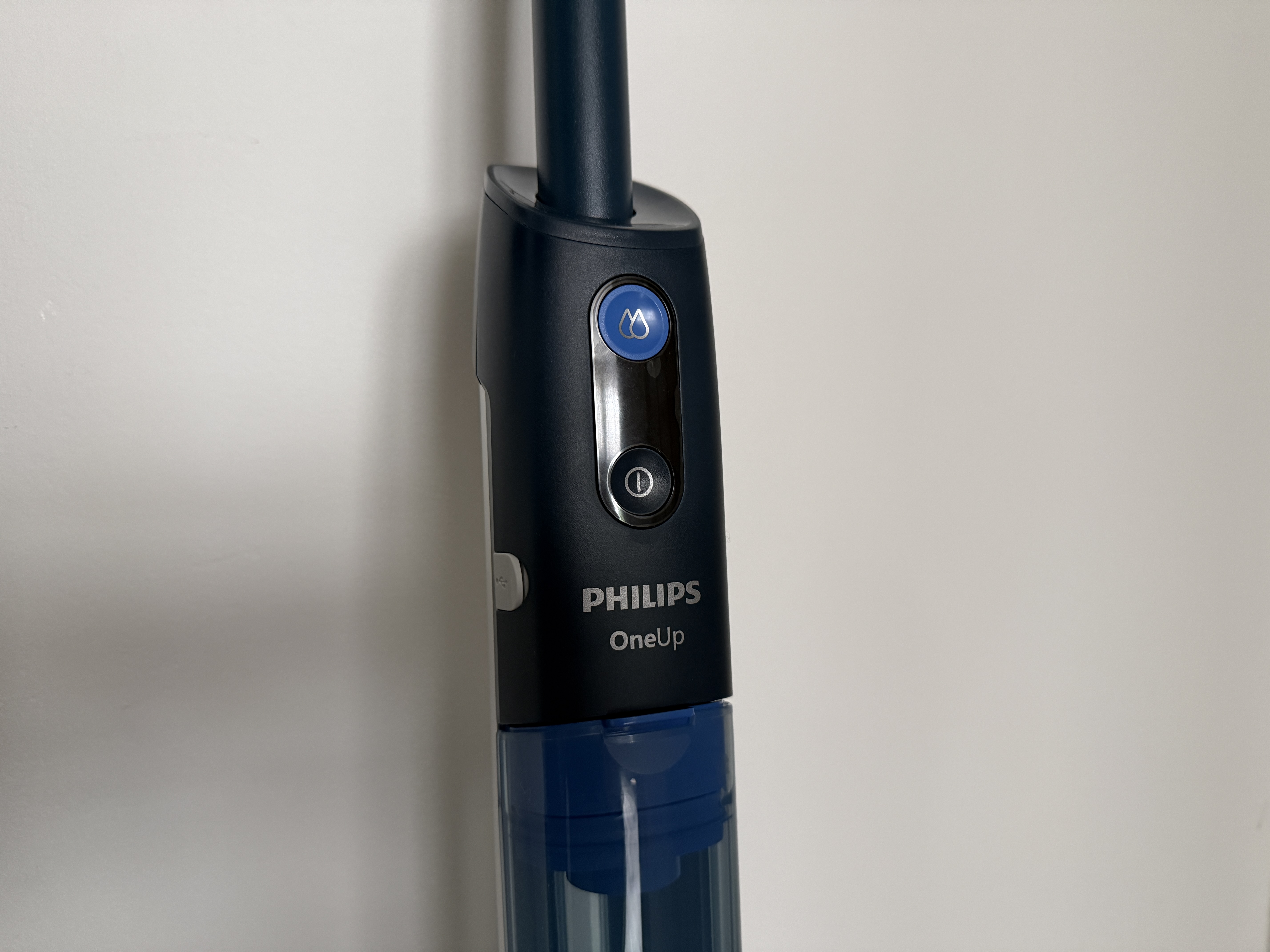 The buttons on a Philips OneUp 5000 electric mop